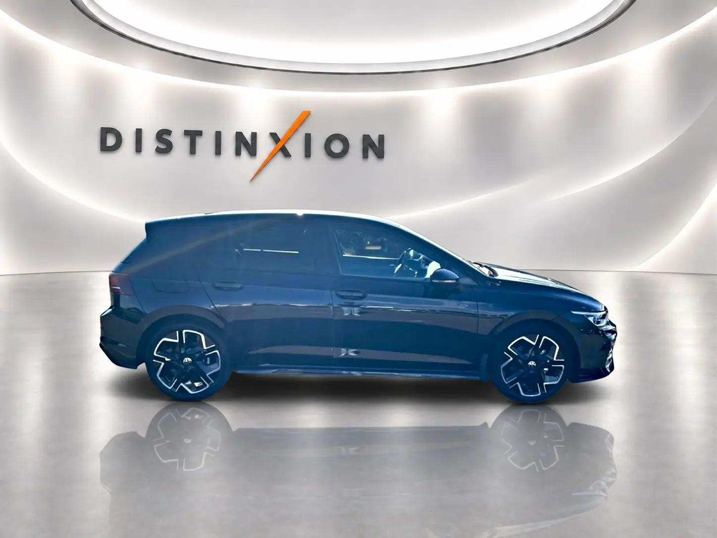 Profil droit d'une Volkswagen Golf noire 2026 R-Line avec jantes 18 pouces dans un showroom lumineux.
