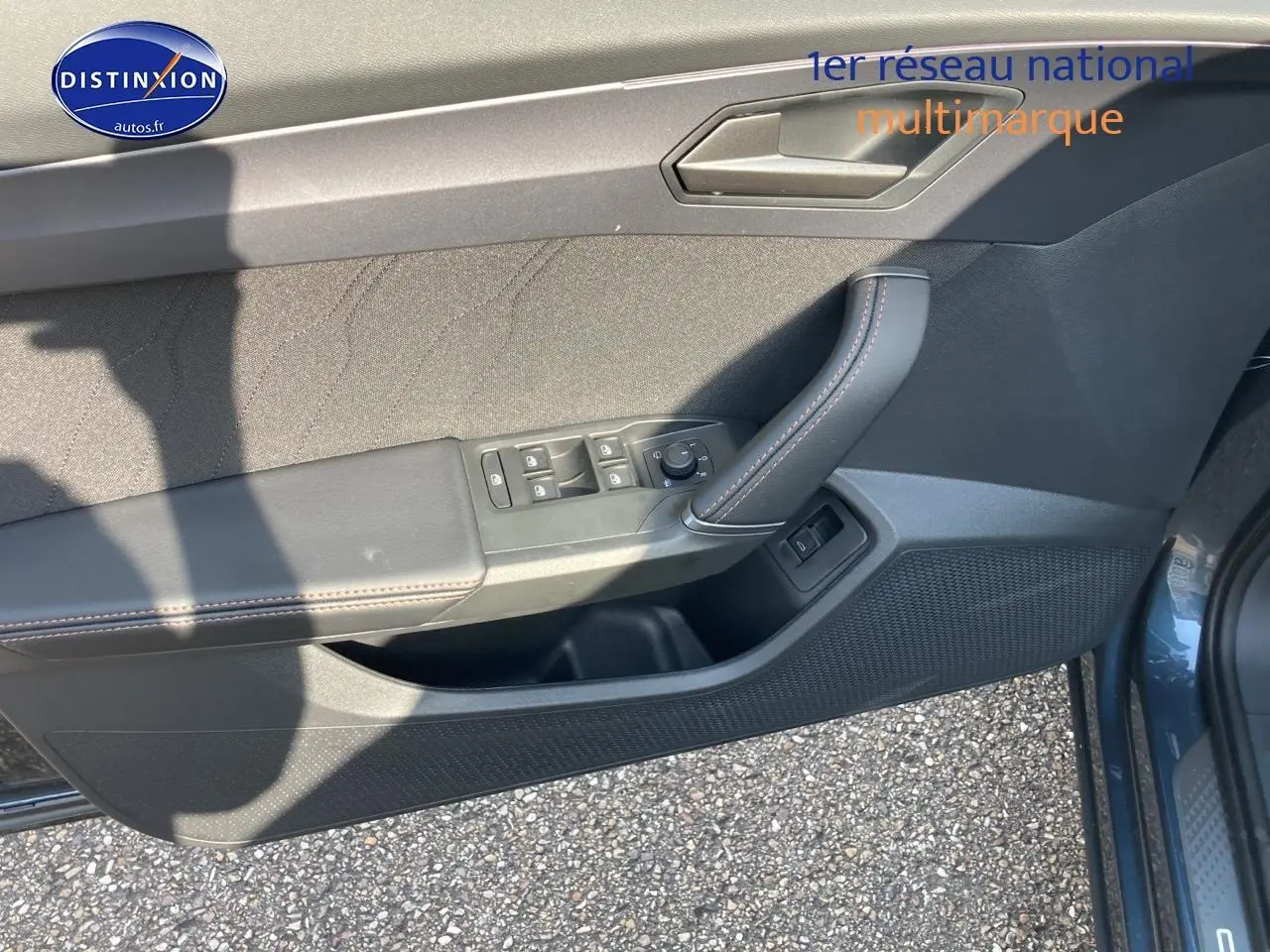 Vue du panneau de porte avant gauche du CUPRA Formentor gris magnétique avec commandes électriques et surpiqûres contrastées.