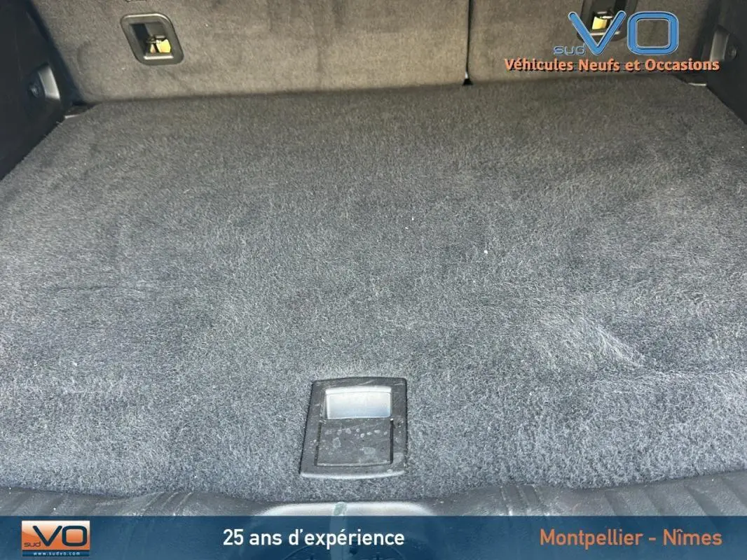 Vue rapprochée du coffre spacieux et tapissé en gris foncé du Jeep Compass noir 2024 e-Hybrid Altitude.