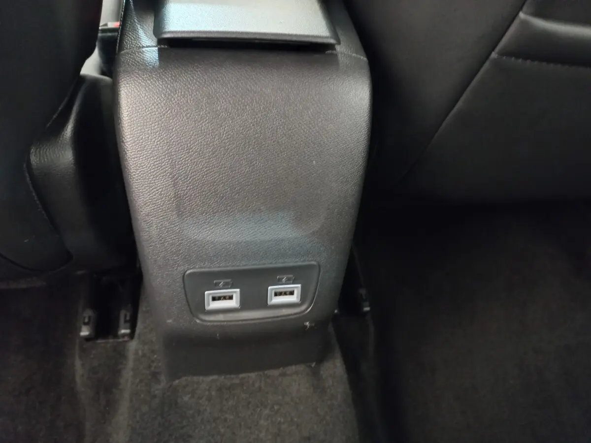 Prise double USB arrière sur console centrale noire dans l'habitacle du Peugeot 208 blanc PureTech 2021