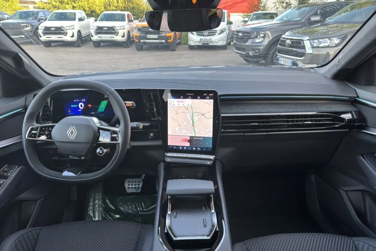 Vue intérieure avant du Renault Austral New 200 Esprit Alpine, tableau de bord noir avec écran tactile vertical et volant multifonctions.