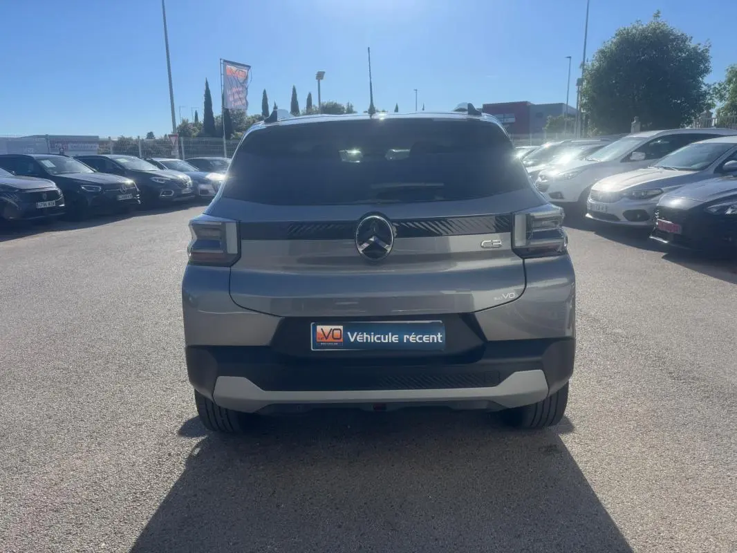 Vue arrière d'une Citroën C3 gris métallisé garée en extérieur sous un ciel ensoleillé.