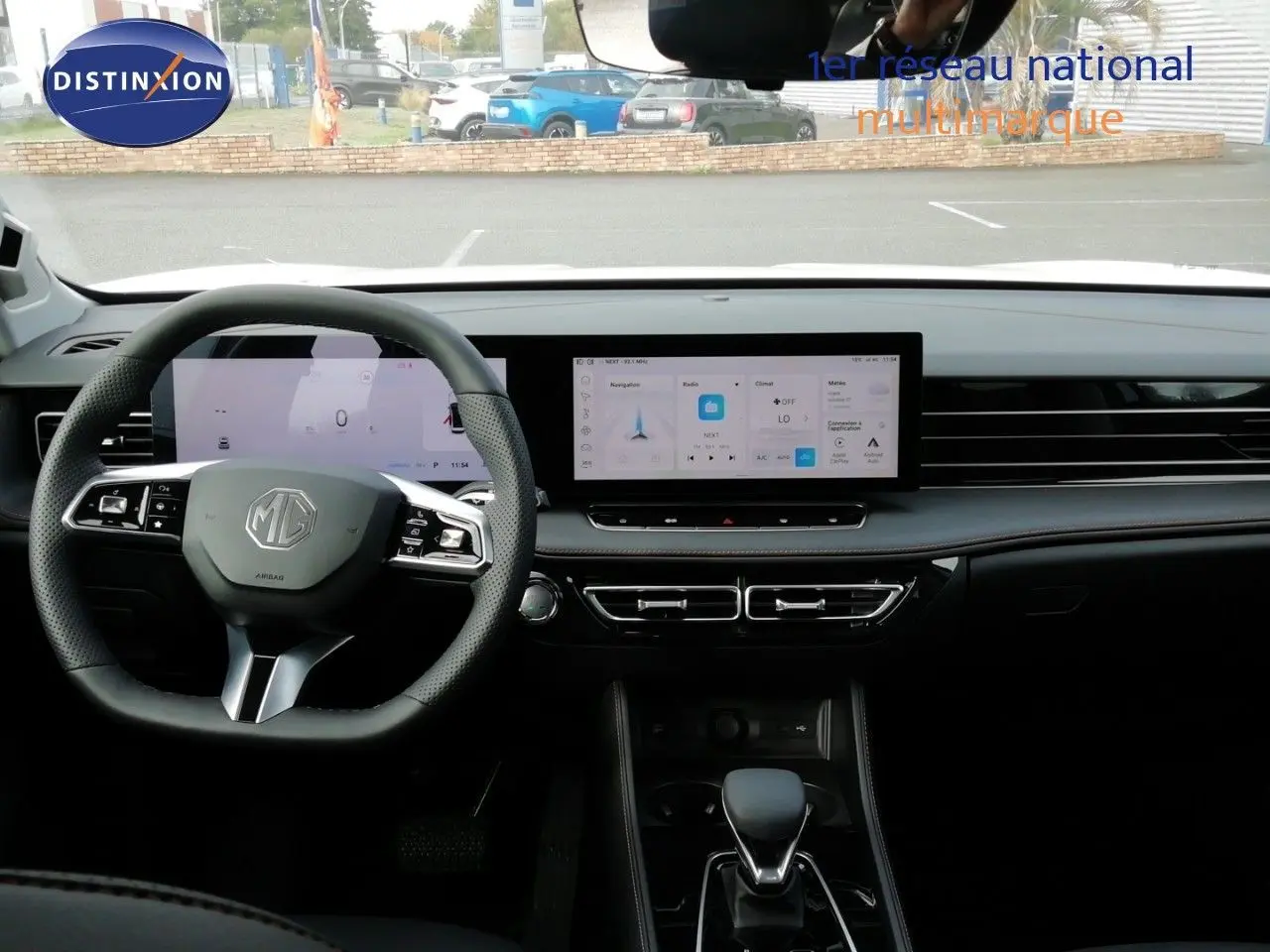 Vue intérieure frontale du tableau de bord et volant noir du MG MOTOR EHS 1.5T PHEV 272CH Luxury avec écran tactile large.