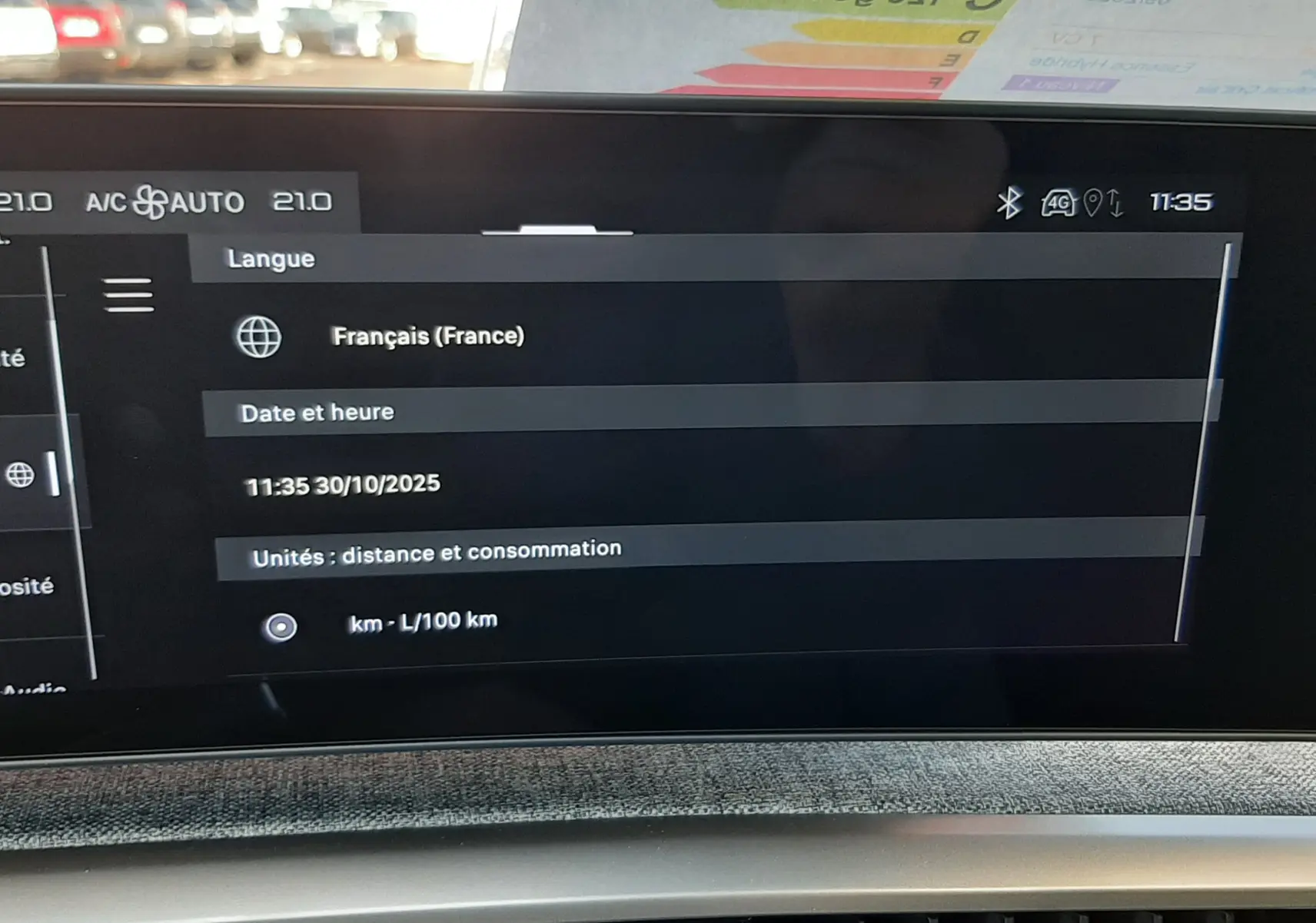 Vue intérieure du tableau de bord numérique du Peugeot 5008 bleu Ingaro, affichant les réglages de langue et date.