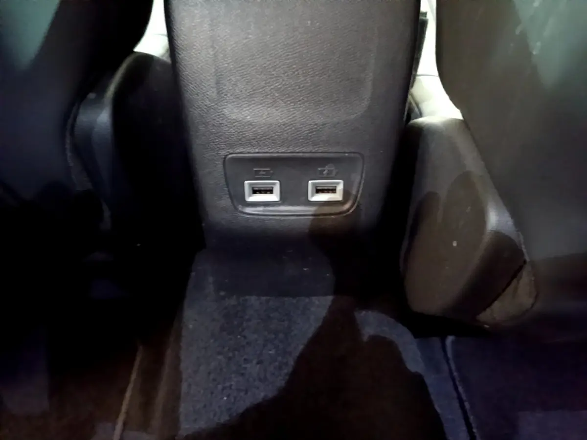 Prise double USB arrière entre les sièges noirs du Peugeot 2008 PureTech 130 S&S Allure Business 2021.