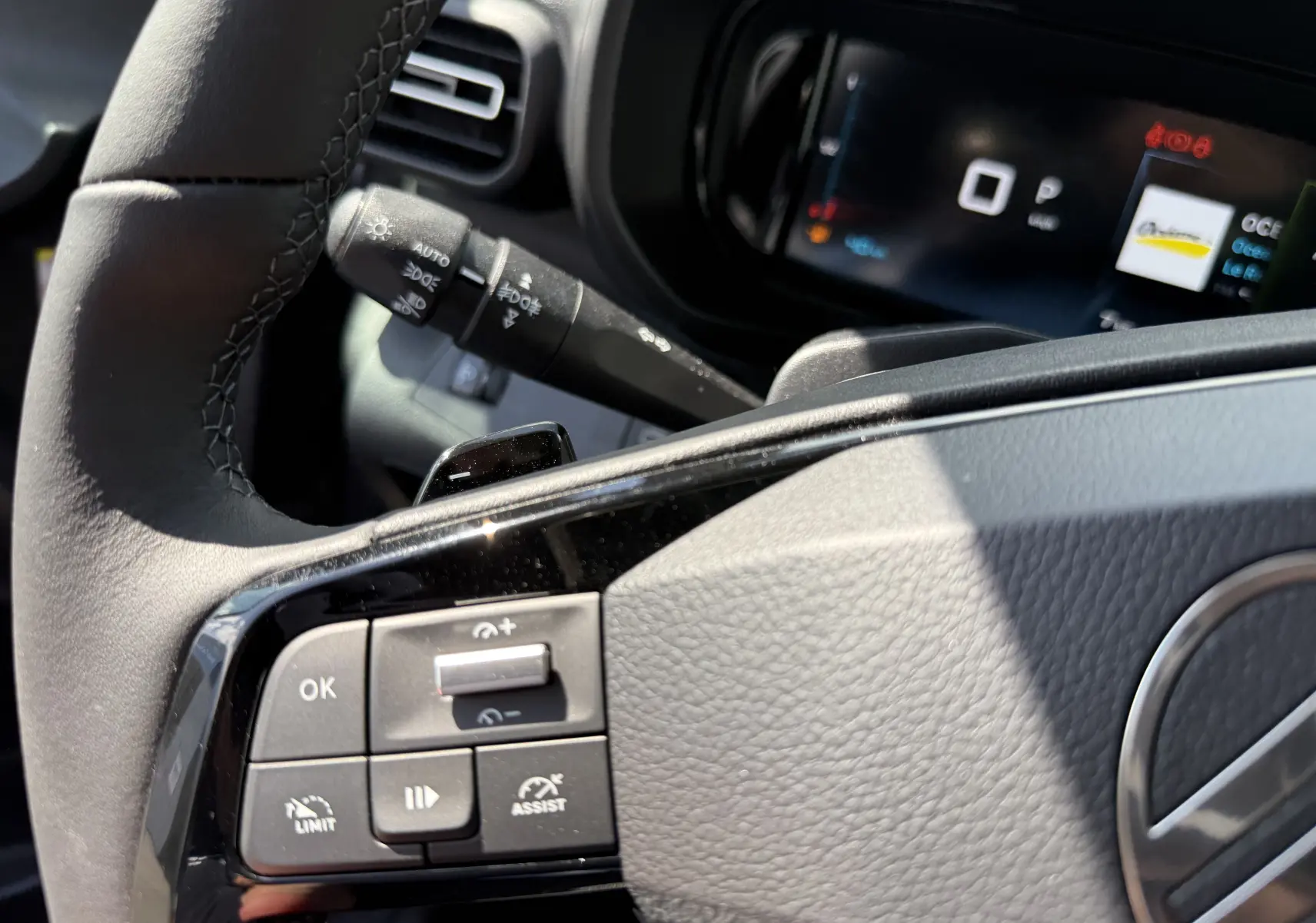 Gros plan sur le volant noir et les commandes multifonctions du Citroën Berlingo 2026, intérieur gris clair.