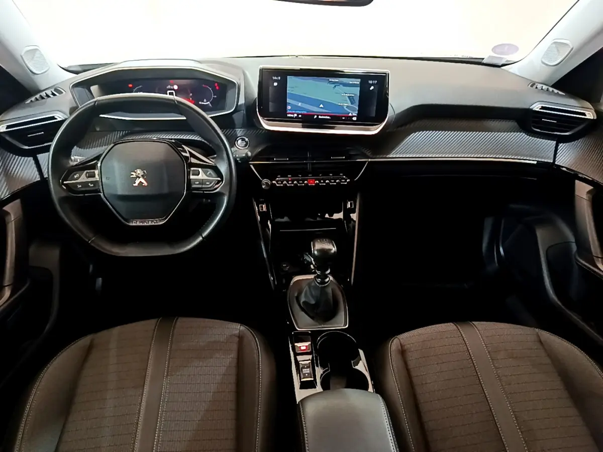 Vue intérieure avant du Peugeot 2008 PureTech 130 avec tableau de bord noir et écran tactile central 10 pouces.