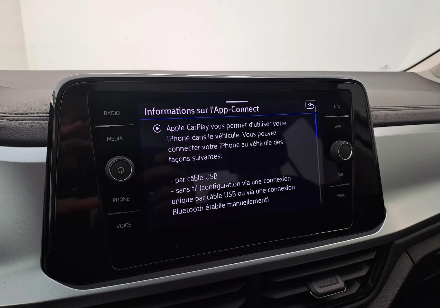 Écran tactile central du Volkswagen T-Roc 2022 affichant les instructions Apple CarPlay, intérieur gris et noir.
