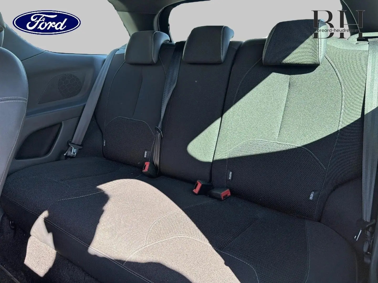 Vue intérieure de la banquette arrière noire d'une Citroën DS3 1.4 HDi70 Chic, avec ceintures de sécurité visibles.