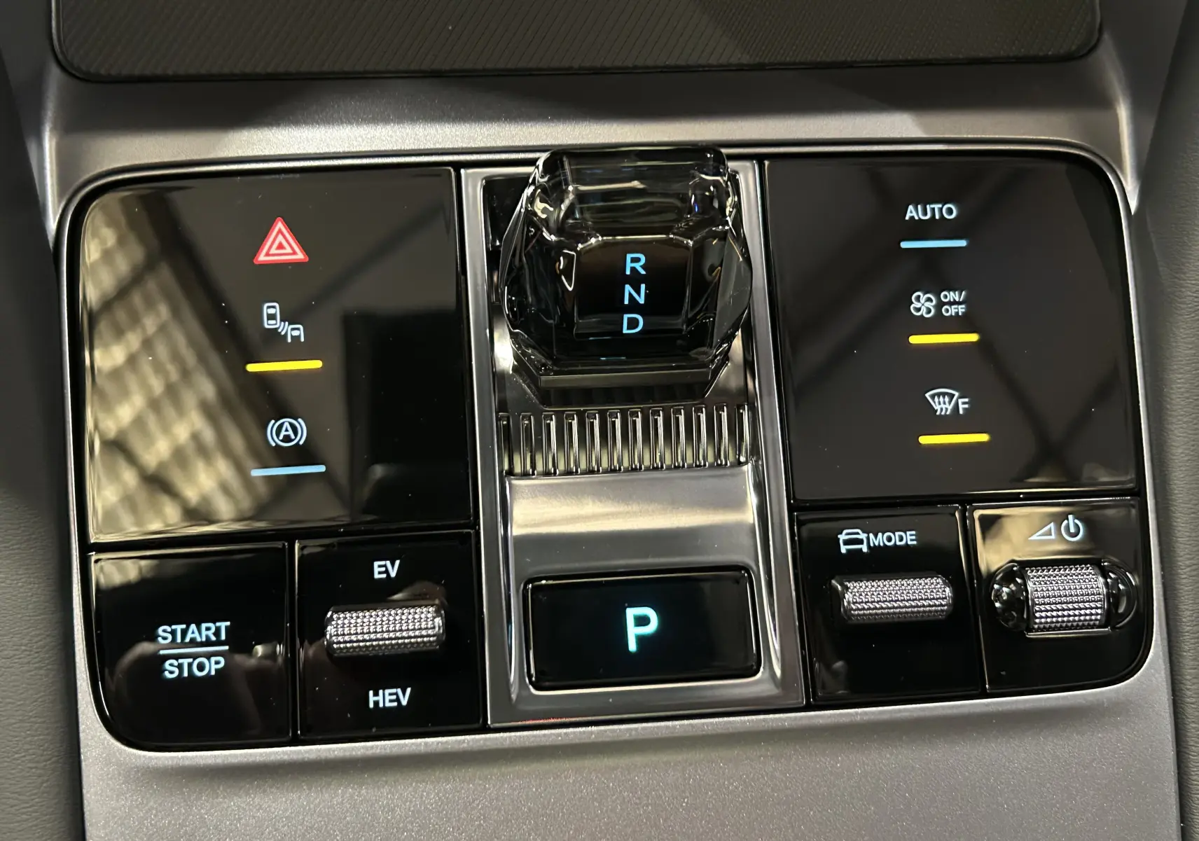 Gros plan sur la console centrale du BYD SEAL U 2025 avec levier de vitesses cristal et commandes tactiles rétroéclairées.