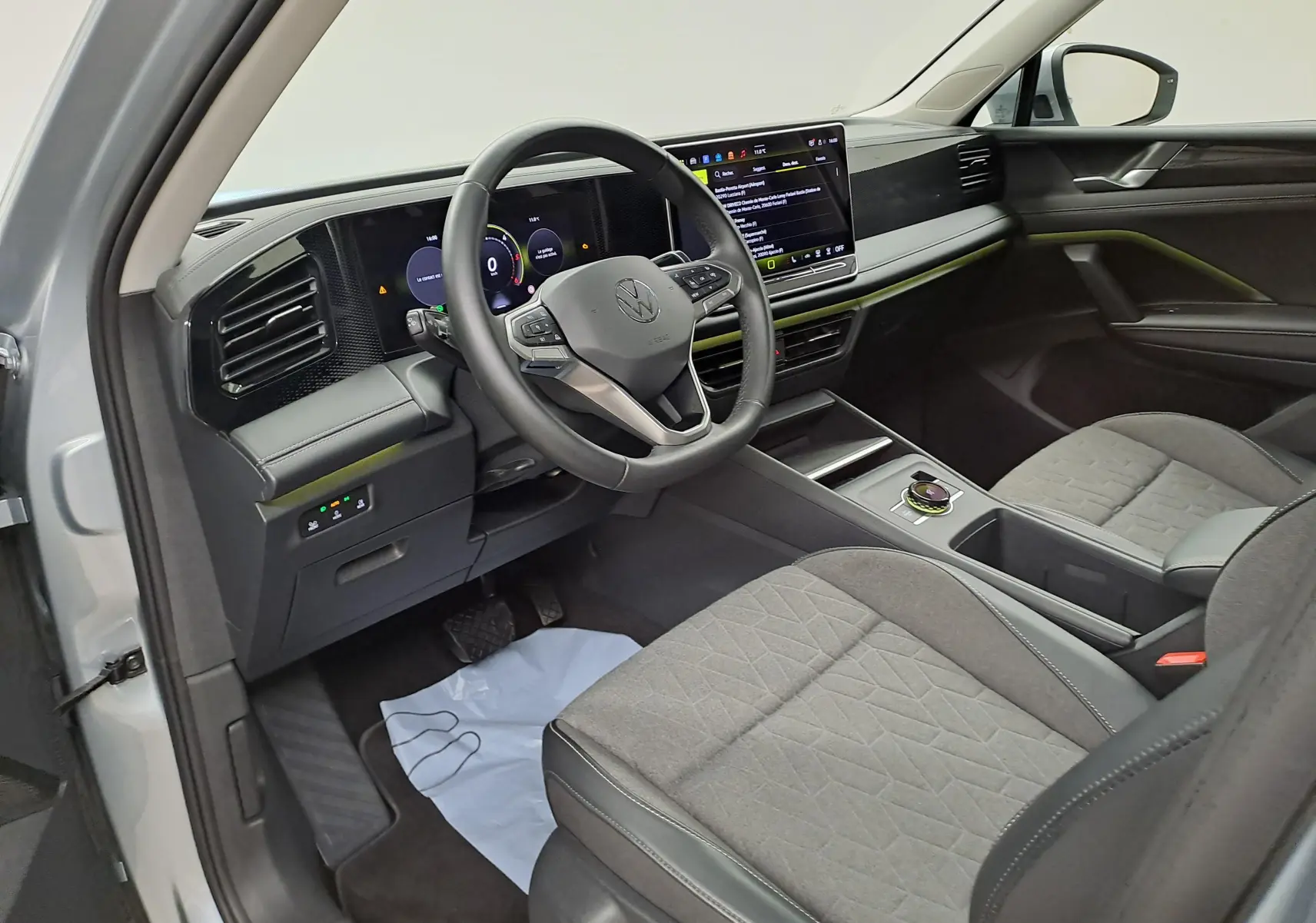 Vue intérieure côté conducteur du Volkswagen Tiguan 2025 avec tableau de bord numérique et volant multifonction noir.