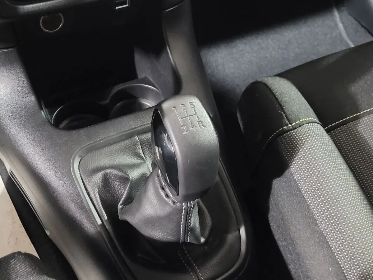 Le levier de vitesses manuel noir de la Citroën C3 PureTech 83 S&S Feel Pack, avec coutures apparentes sur la console centrale.