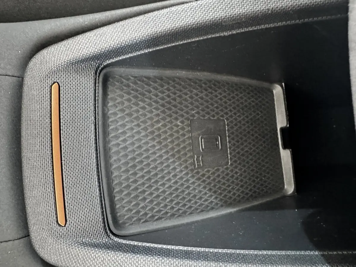Gros plan sur le chargeur à induction noir dans l'habitacle du CUPRA Born 230ch gris foncé.