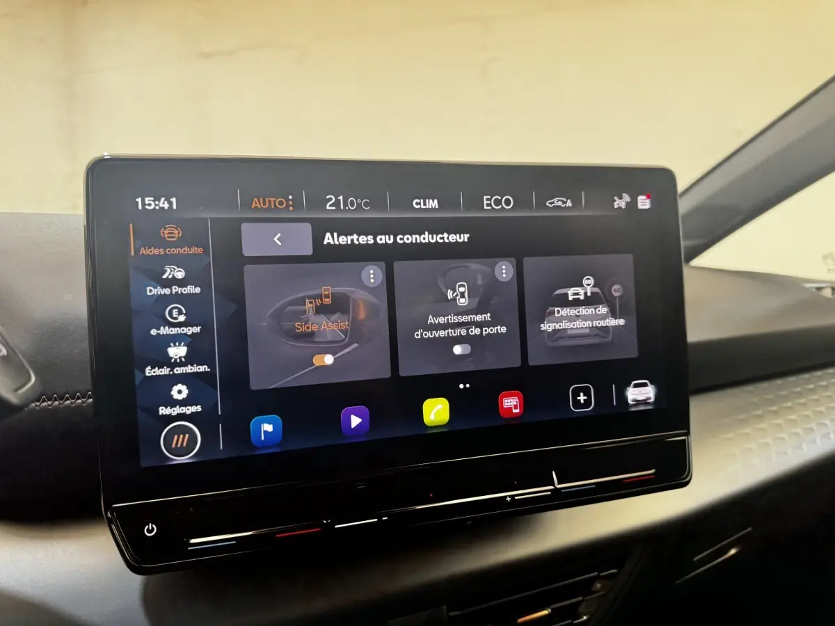 Écran tactile central de la CUPRA BORN 230ch gris foncé, affichant les alertes au conducteur en intérieur.