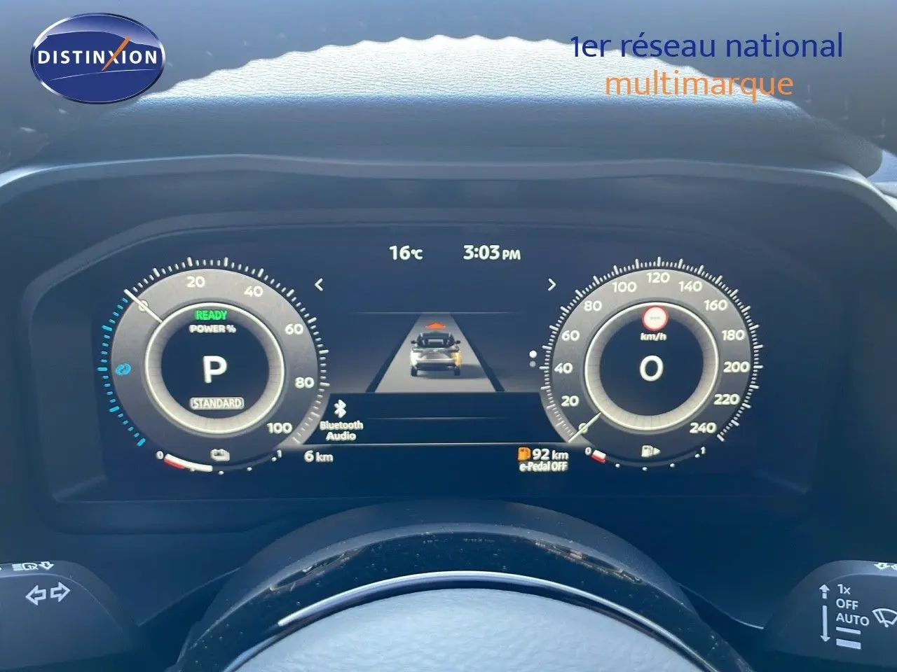 Tableau de bord numérique du Nissan Qashqai 2025 affichant la vitesse, la température et l'autonomie en mode hybride.