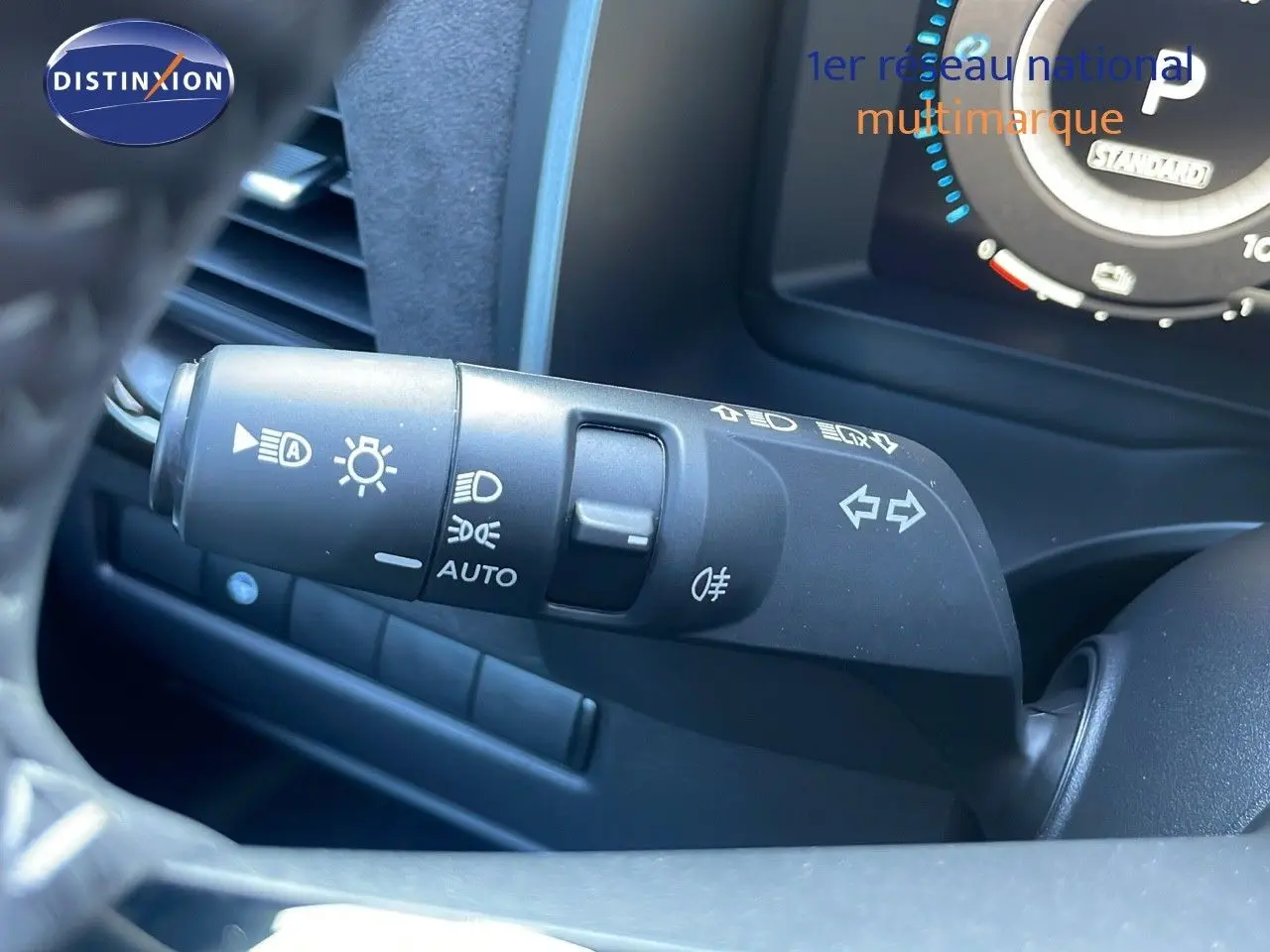 Gros plan sur la commande des phares et clignotants côté gauche du tableau de bord du Nissan Qashqai gris céramique.