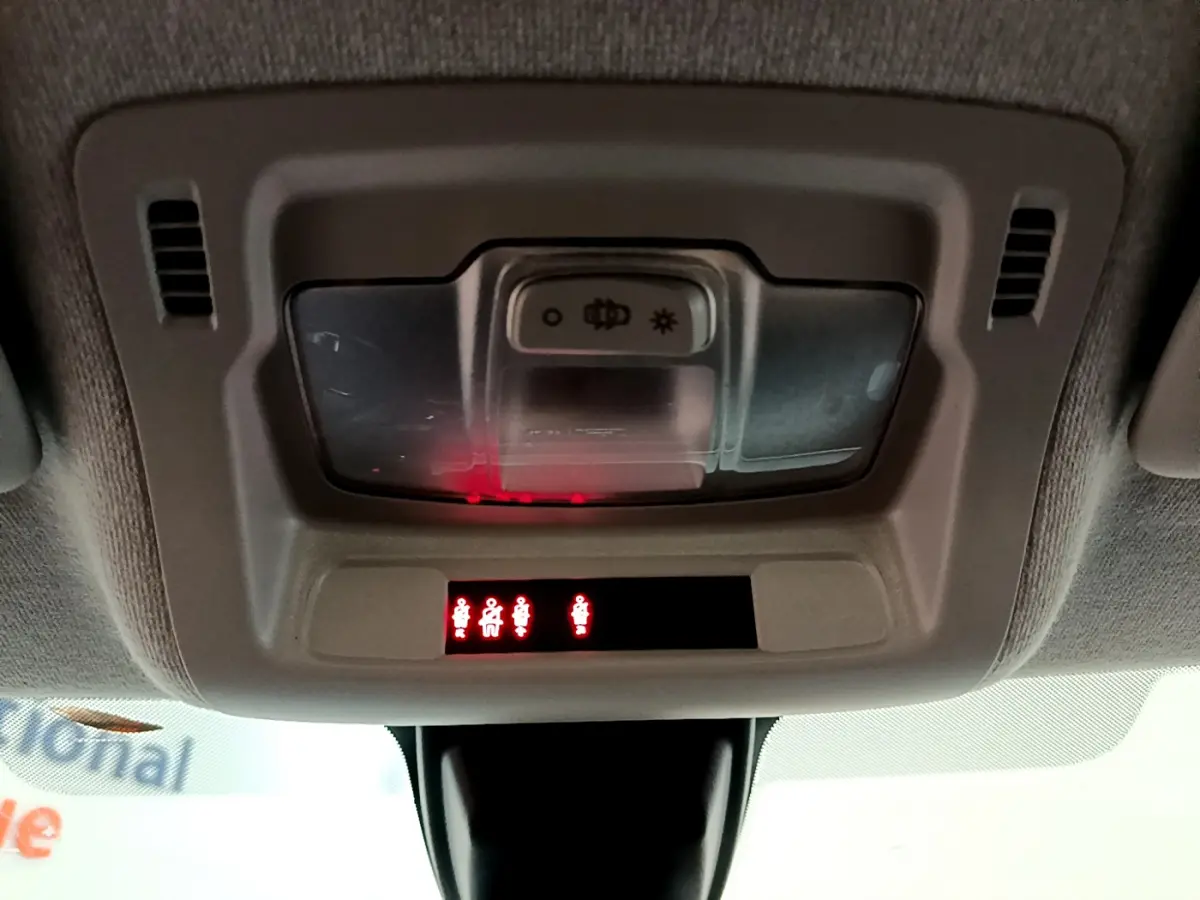 Vue du plafonnier intérieur de la Citroën C3 blanc, avec éclairage et indicateurs de ceinture allumés.