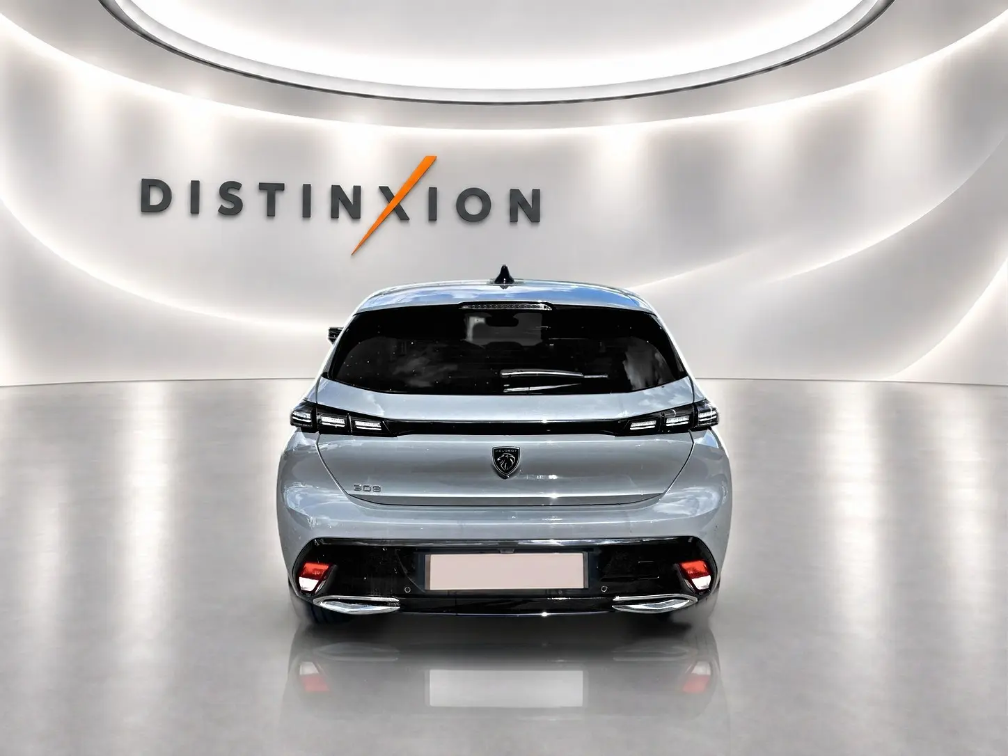 Vue arrière d'une Peugeot 308 gris métallisé 2025, avec feux arrière LED et double sortie d'échappement chromée.