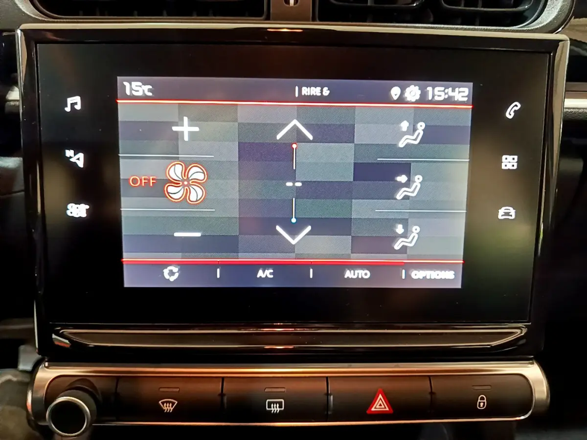 Écran tactile central affichant la climatisation d'une Citroën C3 beige, vue rapprochée de l'intérieur.