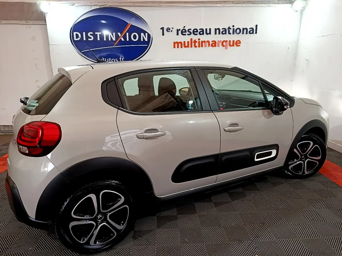 Citroën C3 beige vue de profil côté droit, avec protections noires sur les portières et jantes stylisées.