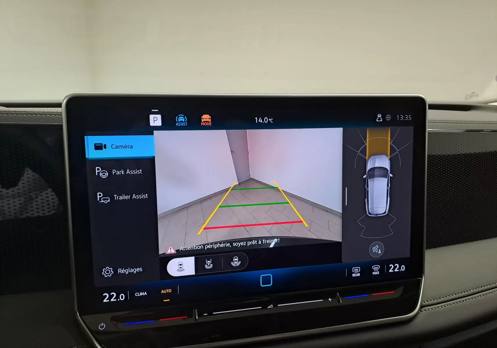 Vue de l'écran tactile du Volkswagen Tiguan 2024 gris Urano montrant l'assistant de stationnement avec remorque en marche.