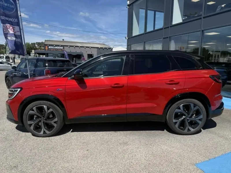 Profil droit du Renault Austral rouge flamme 2023, finition Techno esprit Alpine avec toit noir et jantes distinctives.