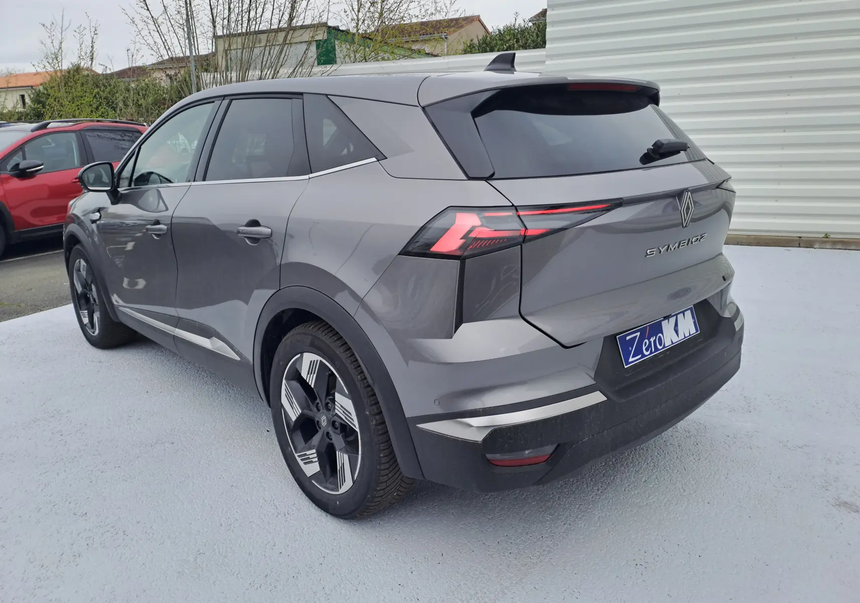 Vue 3/4 arrière droite du Renault Symbioz gris Cassiope avec feux arrière LED et jantes alliage 18 pouces.