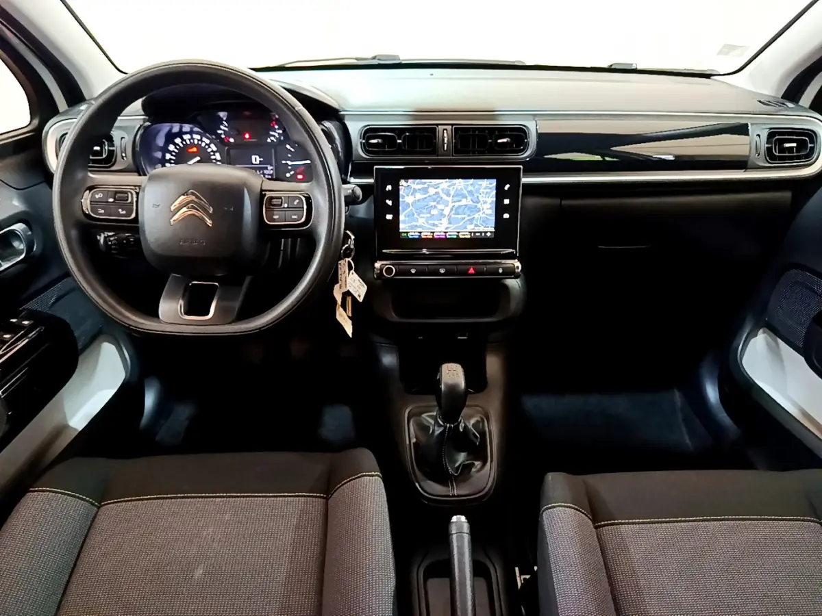 Intérieur de la Citroën C3 blanc, vue frontale du tableau de bord avec écran tactile et volant multifonctions.