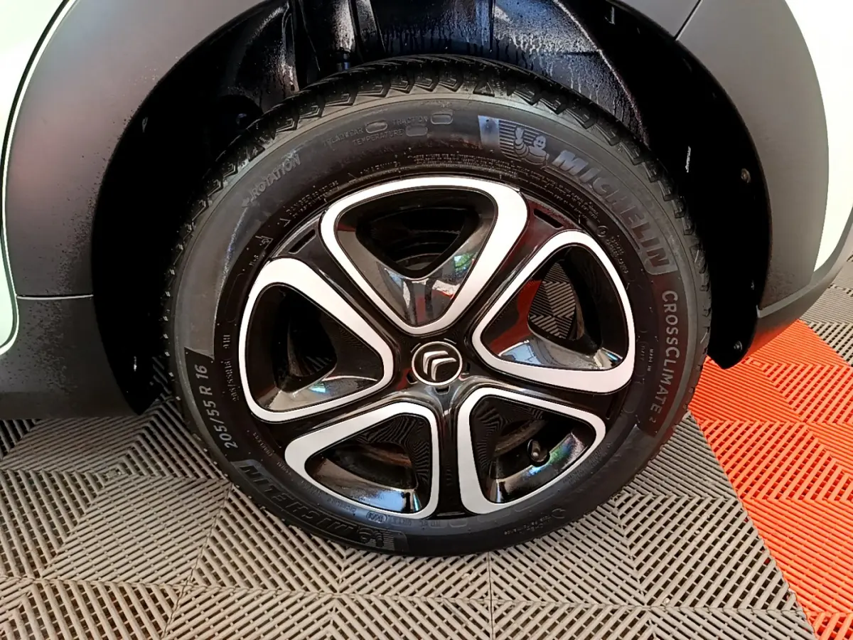 Gros plan sur la roue avant droite de la Citroën C3 PureTech 82 S&S BVM Graphic verte avec jante alliage noire et argentée