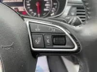 Gros plan sur les commandes chauffantes et de volume au volant d’un Audi A6 Avant gris métal de 2018.