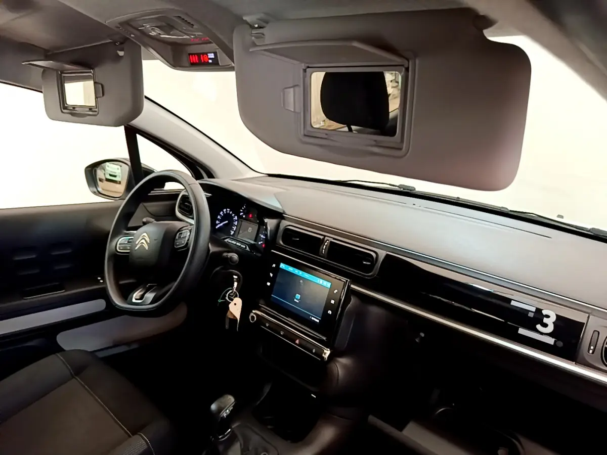 Intérieur de la Citroën C3 PureTech 82 vue côté conducteur, tableau de bord noir avec écran tactile 7 pouces.