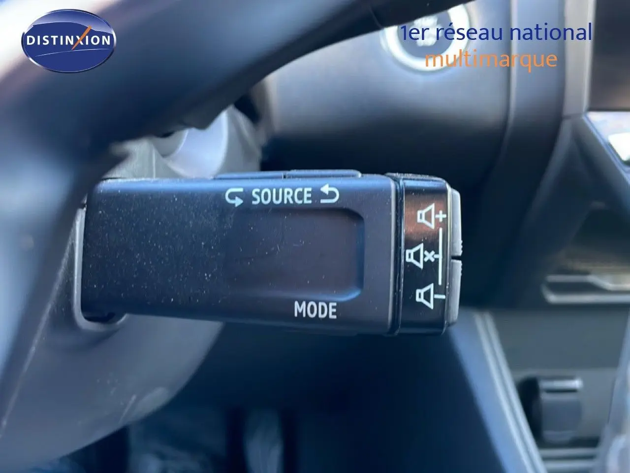 Gros plan sur la commande au volant du Renault Captur 2025, version rouge désir métal avec toit noir.