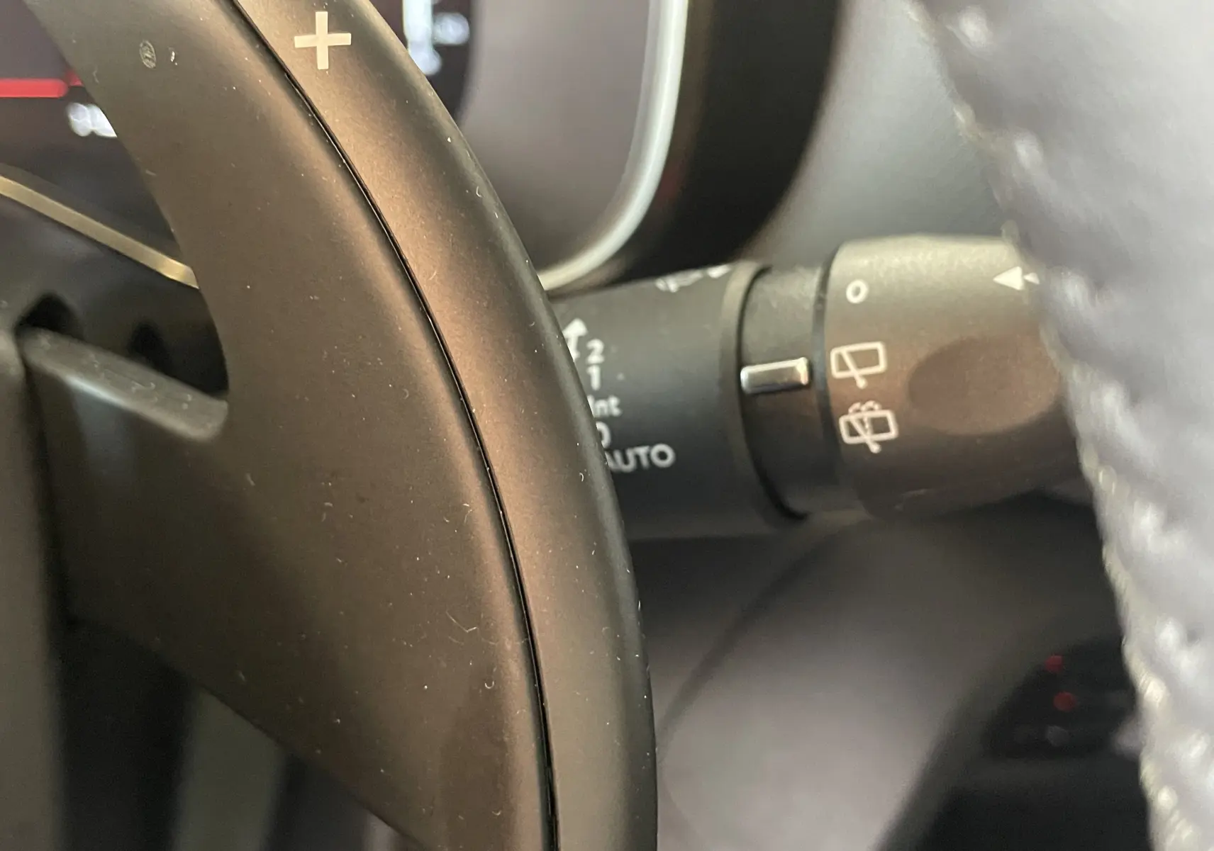 Gros plan sur la palette de changement de vitesse au volant d’un Citroën C5 Aircross gris platinium, intérieur sombre.