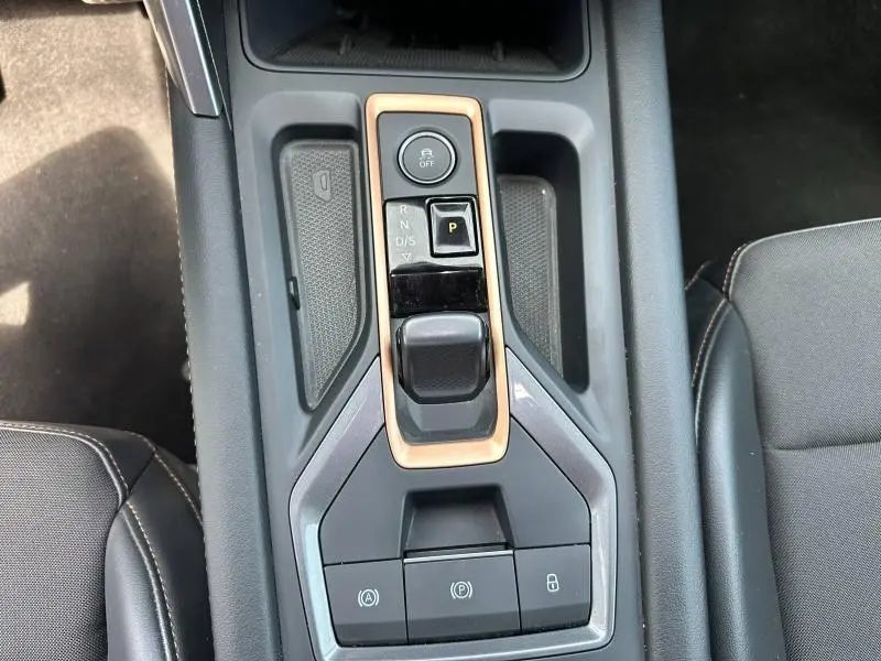 Vue rapprochée de la console centrale avec levier de vitesse automatique et boutons de contrôle sur la CUPRA Formentor bleu.