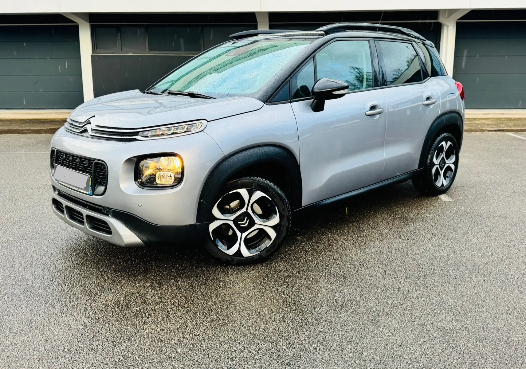Citroën C3 Aircross gris Artense vue 3/4 avant droit avec toit noir et jantes alliage 17 pouces.