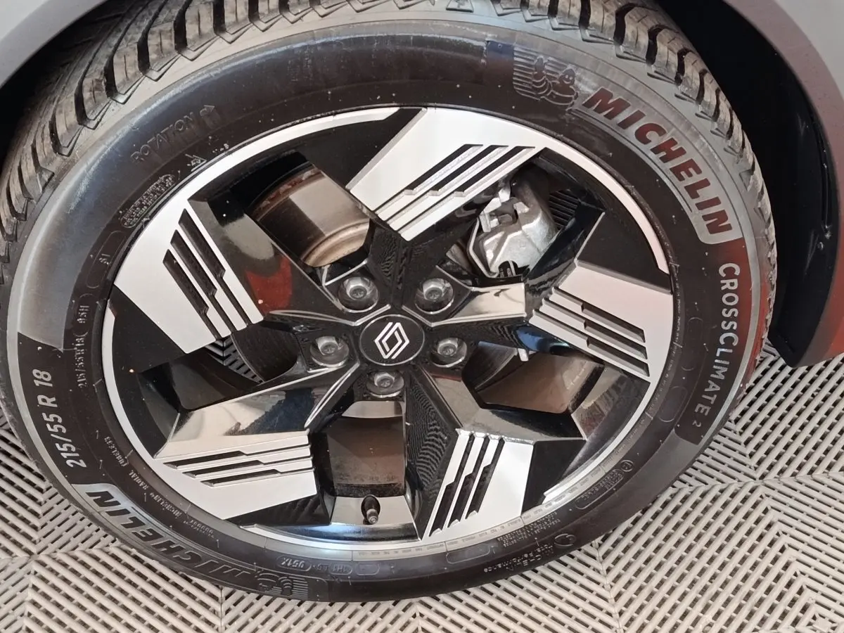 Gros plan sur la roue avant droite du Renault Symbioz noir, jante alliage bicolore au design moderne.