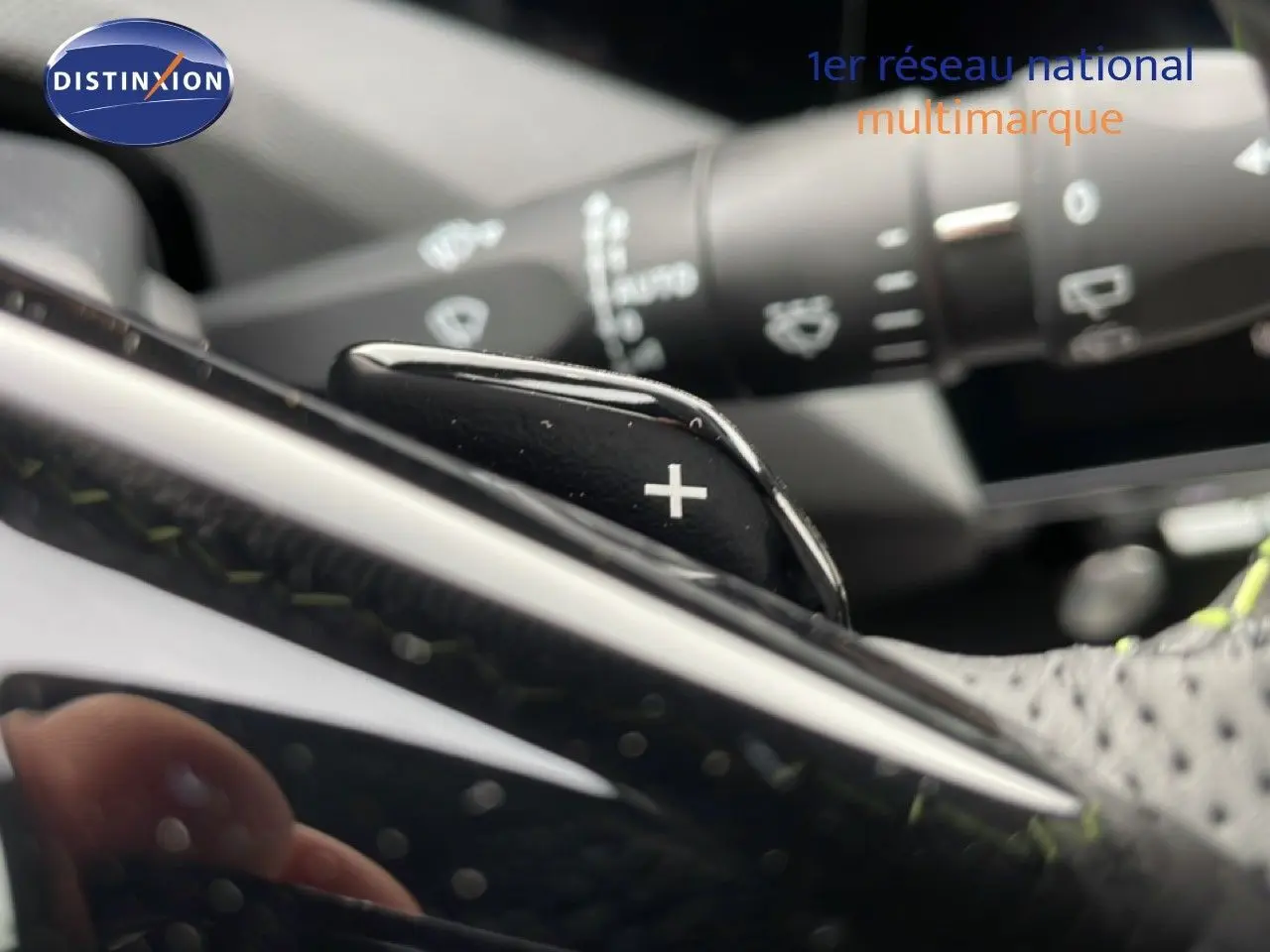Gros plan sur la palette de changement de vitesse "+" côté droit du volant d'une Peugeot 308 gris Selenium 2026.