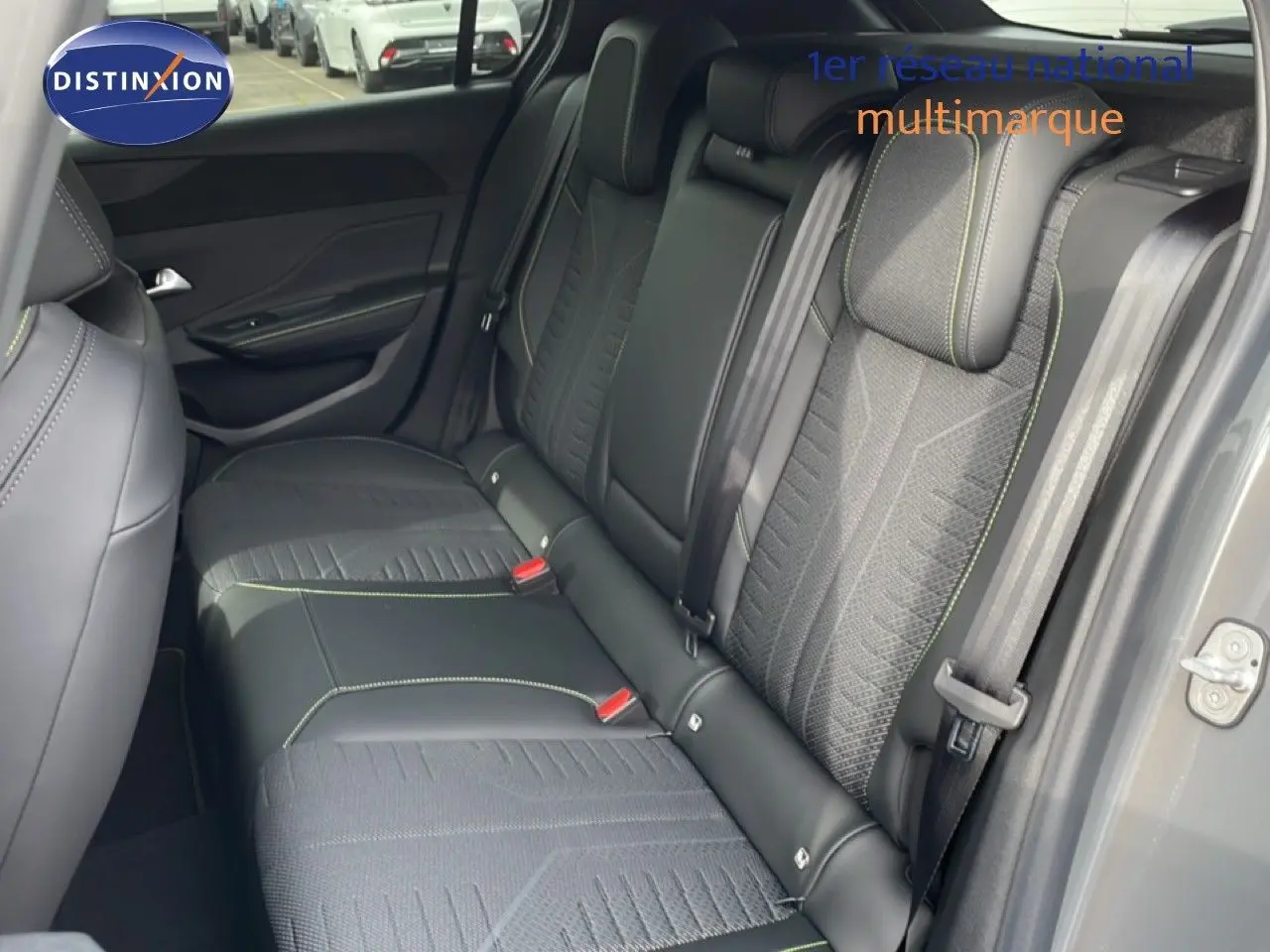 Vue intérieure côté droit des sièges arrière en tissu et cuir noir avec surpiqûres vertes d'une Peugeot 308 gris selenium métal 2026.