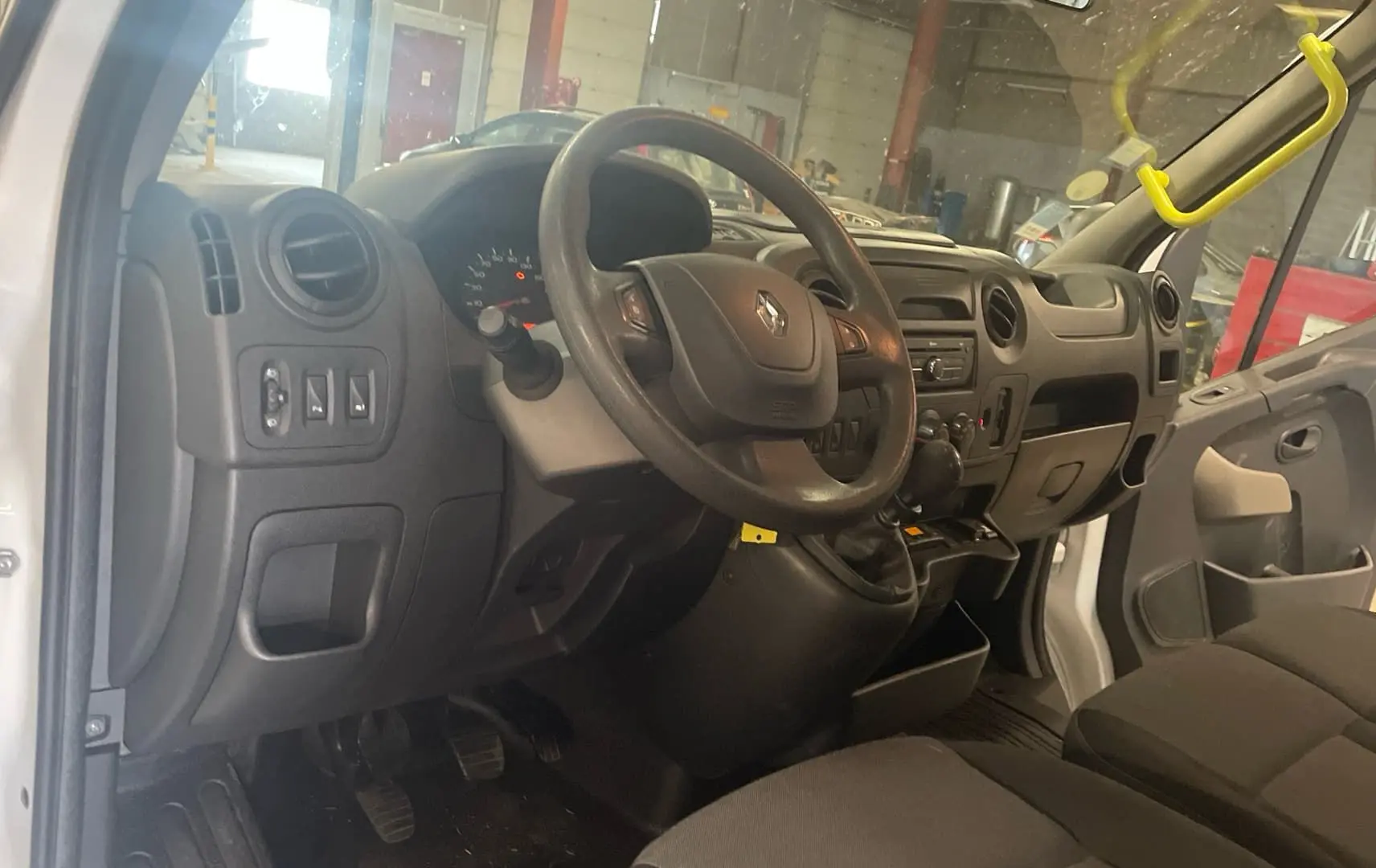 Vue intérieure côté conducteur du Renault Master blanc 2019, montrant le tableau de bord et le volant.