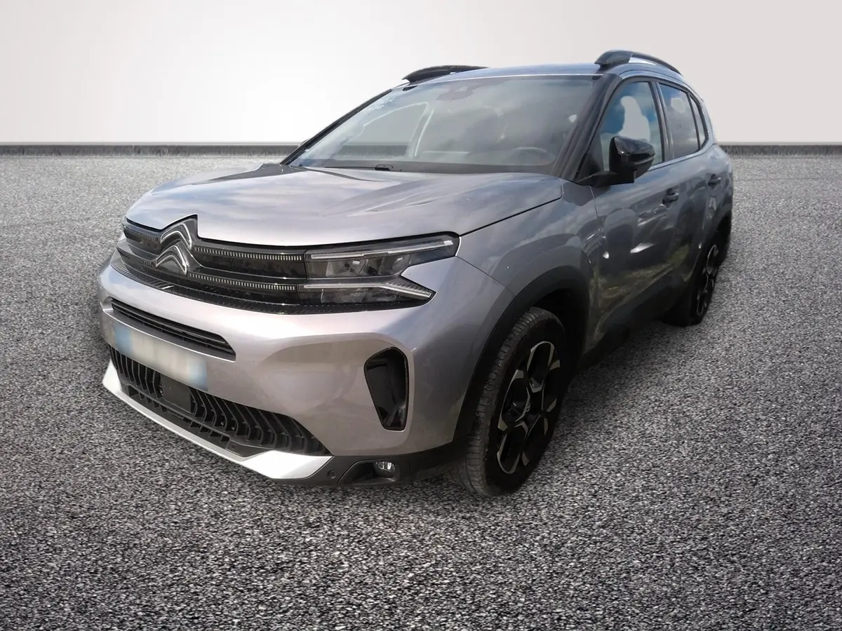 Citroën C5 Hybride gris clair vue 3/4 avant droit avec calandre noire et jantes noires distinctives.