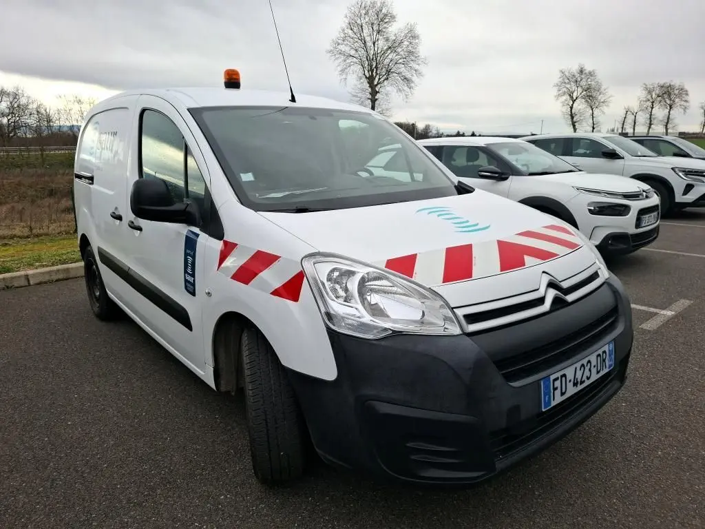 Vue 3/4 avant gauche d'un Citroën Berlingo blanc utilitaire avec bandes rouges diagonales et gyrophare orange sur le toit.