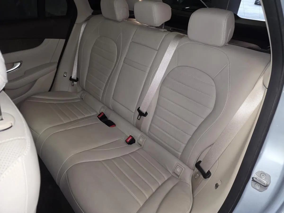 Vue intérieure de la banquette arrière en cuir beige clair d'une Mercedes GLC 350 e hybride rechargeable, côté droit ouvert.