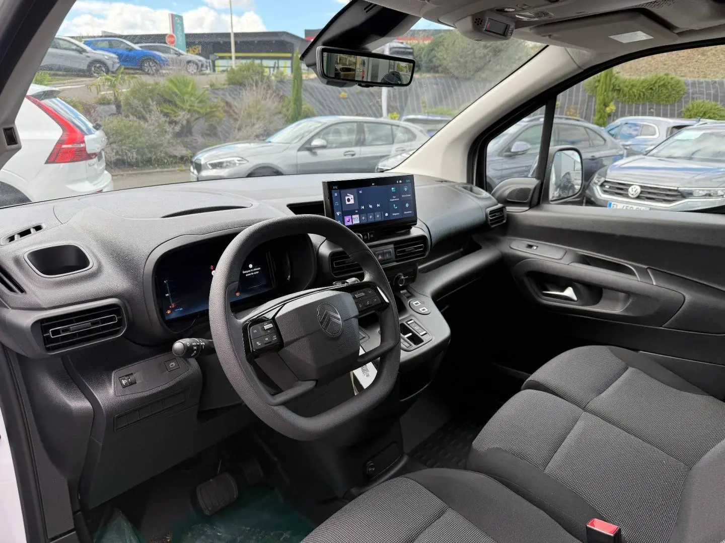 Intérieur avant droit du Citroën Berlingo Fourgon XL Diesel blanc, tableau de bord moderne avec écran tactile et volant multifonction.