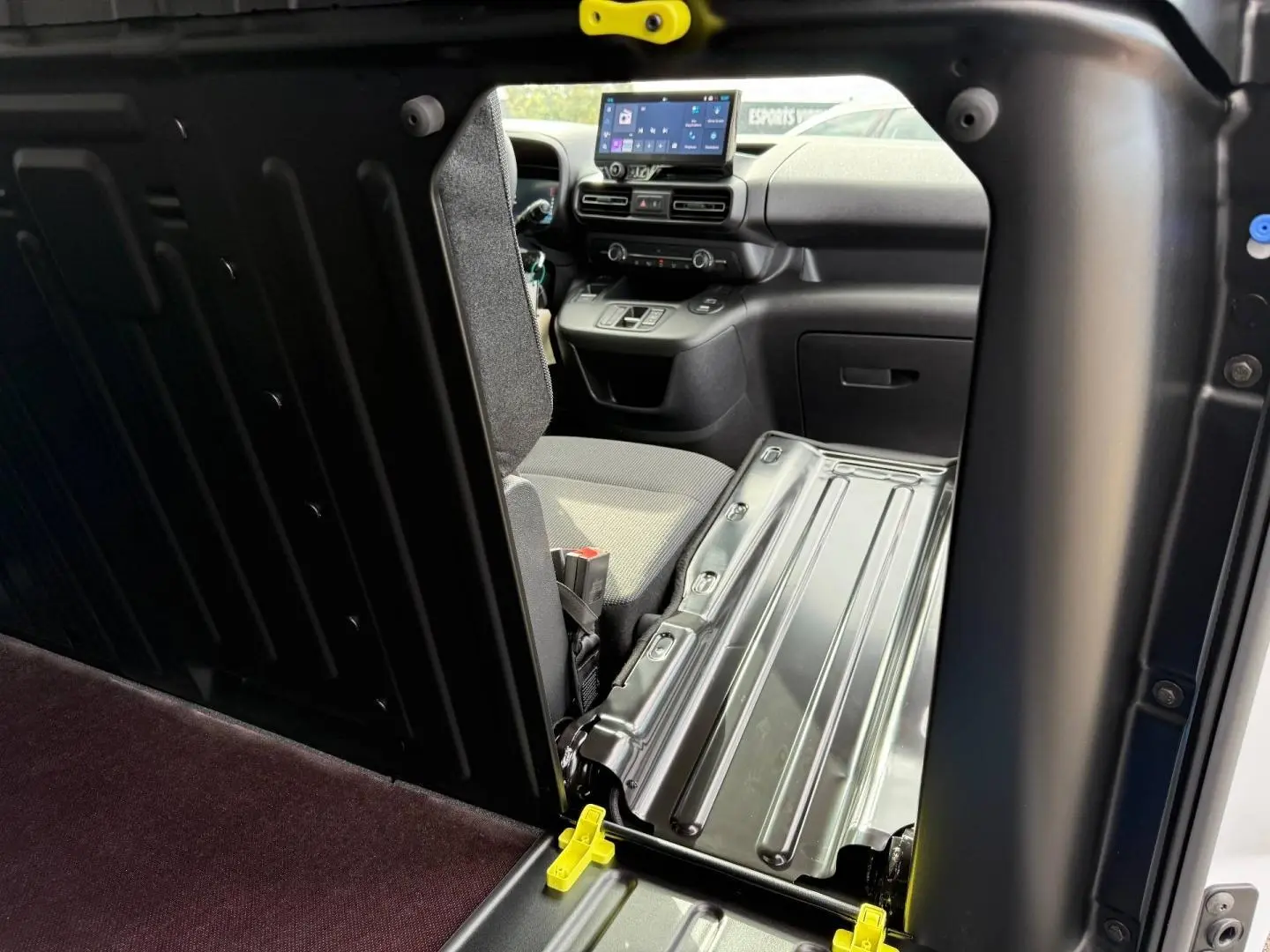 Vue intérieure du Citroën Berlingo Fourgon XL Diesel blanc Icy, montrant la cloison et le poste de conduite.