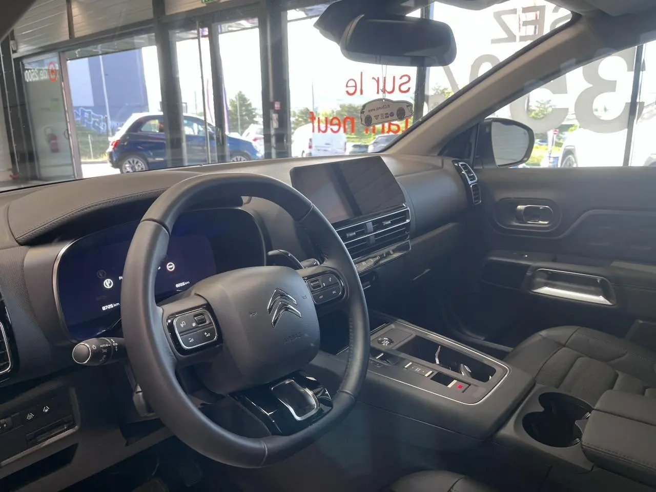 Intérieur de Citroën C5 Aircross blanc nacré, vue côté conducteur, volant cuir et écran tactile central.