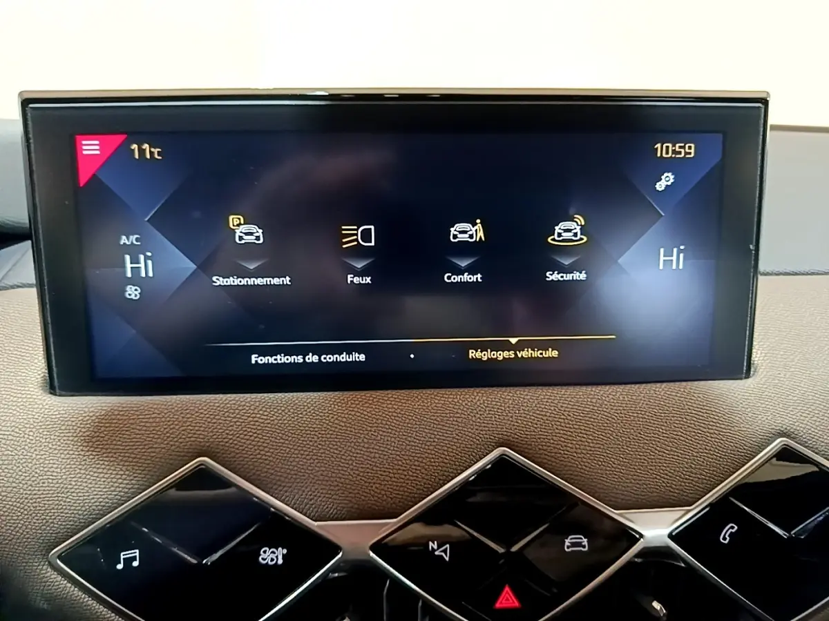 Écran tactile central du tableau de bord du DS3 Crossback bleu, affichant les réglages de conduite et sécurité.