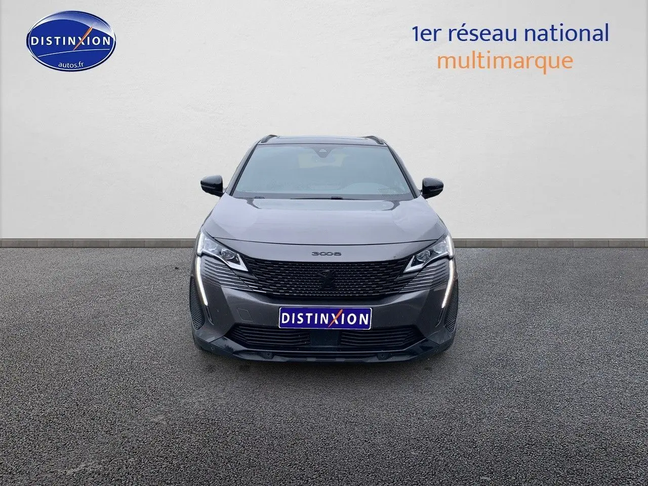 Vue frontale d'un Peugeot 3008 gris platinium métal avec calandre noire et feux LED verticaux allumés.