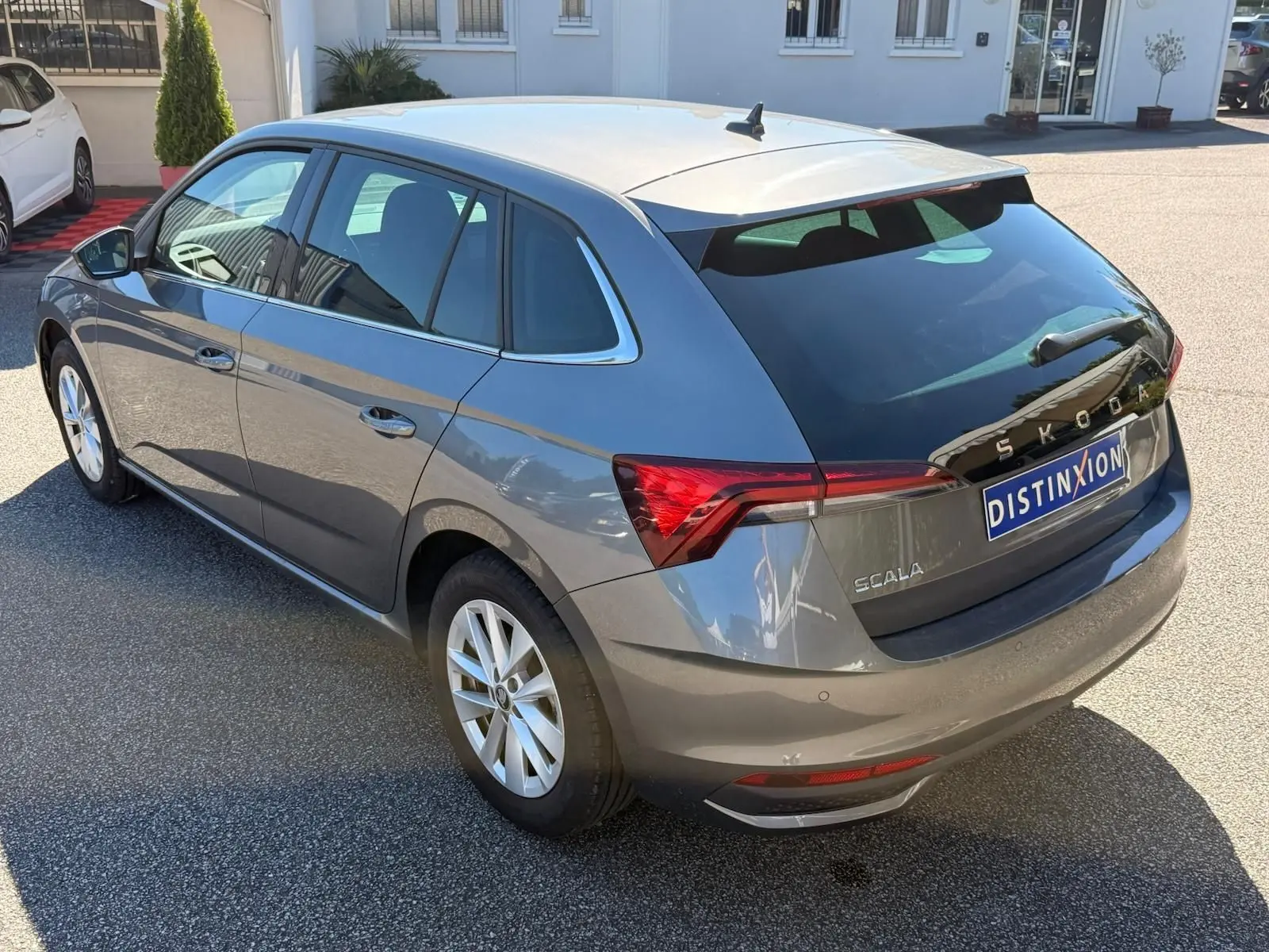 Vue 3/4 arrière droite d'une Skoda Scala gris graphite 2025 avec feux arrière LED et jantes alliage.