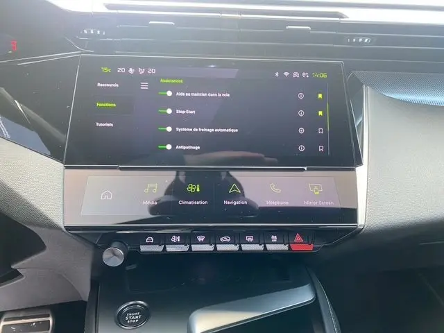 Vue rapprochée de l'écran tactile central et des commandes du tableau de bord de la Peugeot 308 SW blanc nacré, version 2022.