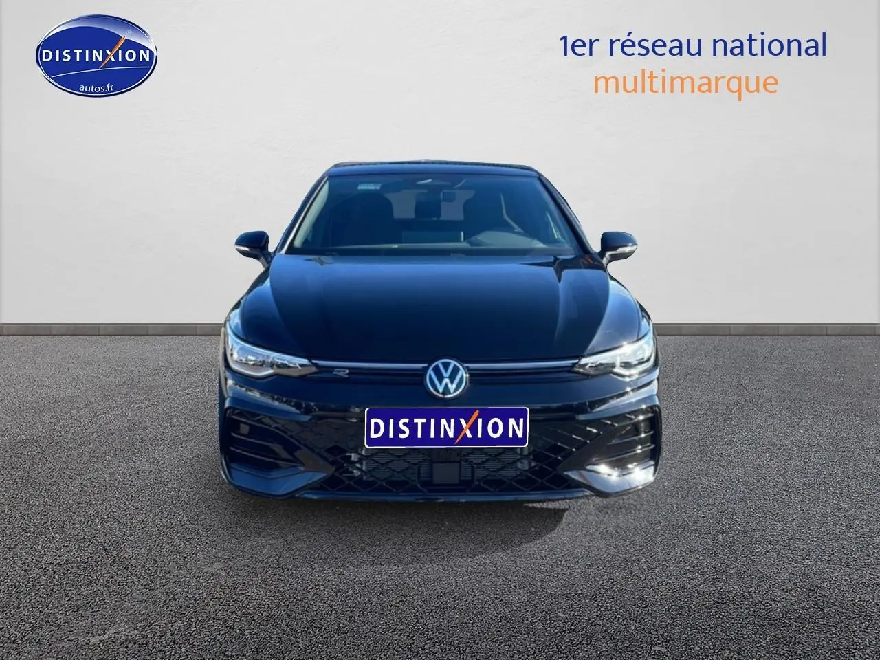 Vue de face d'une Volkswagen Golf noire 2026 avec calandre R-Line et phares LED allumés.